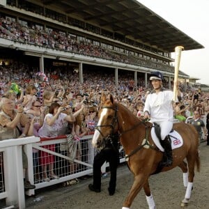 Zara Phillips et Toytown à l'hippodrome de Cheltenham le 23 mai 2012, portant la flamme olympique dans le cadre du relais à quelques semaines des JO de Londres. Toytown est mort à l'âge de 24 ans le 27 juin 2017.