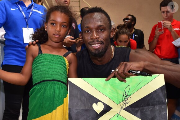 Usain Bolt est sous le charme de la petite Morley qui lui a offert le dessin qu'elle a fait pour son héros, durant le meeting international d'athlétisme Herculis 2017 à Monaco, au stade Louis II le 21 juillet. © Bruno Bebert/Bestimage