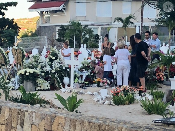 Laeticia Hallyday, ses filles Jade et Joy, Elyette Mamie rock (grand-mère de L. Hallyday), Jean Reno et sa femme Zofia se recueillent sur la tombe de Johnny Hallyday le lendemain de l'enterrement au cimetière marin de Lorient sur l'île Saint-Barthélemy, le 12 décembre 2017.