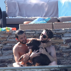 Exclusif - Christophe Beaugrand et son mari Ghislain Gerin en vacances avec des amis et leur chienne Colby à Saint-Tropez le 31 juillet 2018.