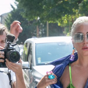 Lady Gaga arrive aux Studios de l'Olivier à Malakoff, le 28 août 2018. Elle porte un manteau bleu et des bottines style Drag Queen.