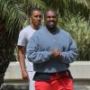 Exclusif - Kanye West à la sortie d'un immeuble à Los Angeles, le 3 avril 2019  For germany call for price Exclusive - Artist Kanye West leaves an office in Los Angeles and has an entourage hop inside his custom Lambo truck. Ye rocked bright red pants with a garment dyed blue sweatshirt and of course, his signature Yeezy 700 sneakers. 3rd april 201903/04/2019 - Los Angeles