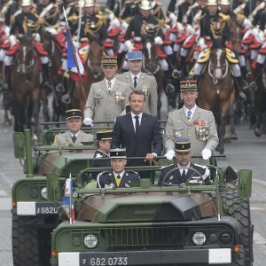 Emmanuel Macron, président de la République Française, descend les Champs-Elysées au côté du Général François Lecointre (chef d'État-Major des armées) à bord d'un Camion ACMAT VLRA, afin de rejoindre la tribune présidentielle et assister au défilé militaire du 14 juillet. Paris, le 14 juillet 2019. © Lemouton-Gorassini-Perusseau/Bestimage