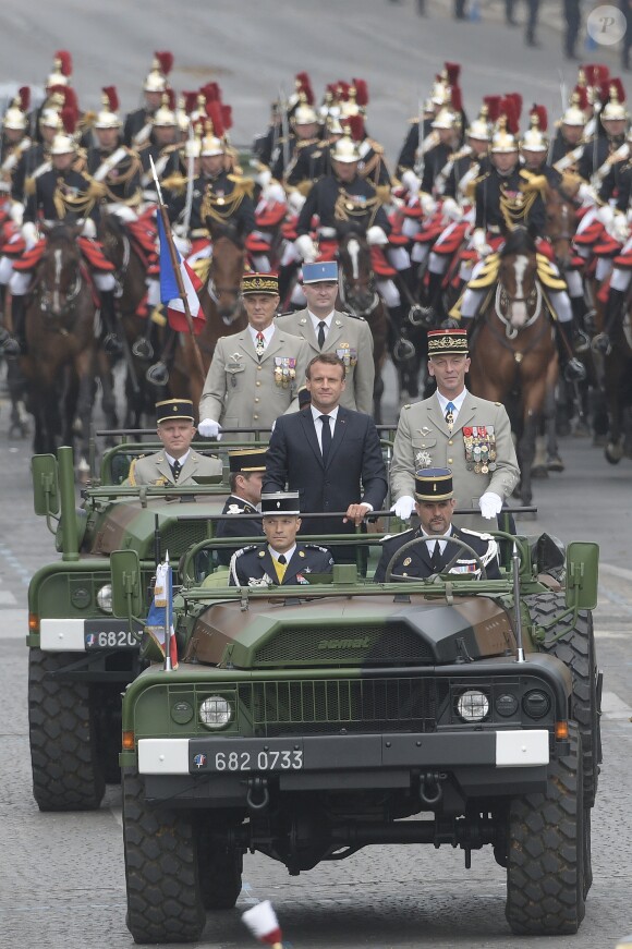 Emmanuel Macron, président de la République Française, descend les Champs-Elysées au côté du Général François Lecointre (chef d'État-Major des armées) à bord d'un Camion ACMAT VLRA, afin de rejoindre la tribune présidentielle et assister au défilé militaire du 14 juillet. Paris, le 14 juillet 2019. © Lemouton-Gorassini-Perusseau/Bestimage
