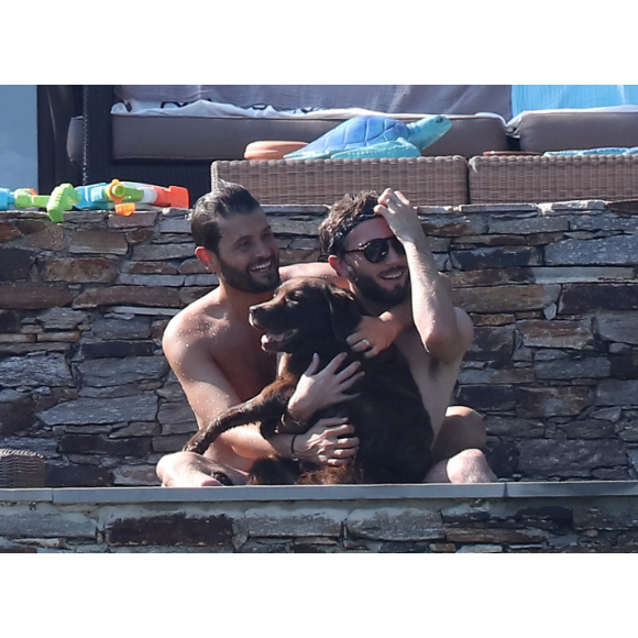 Exclusif - L'animateur Christophe Beaugrand et son mari Ghislain Gerin en vacances avec des amis et leur chienne Colby à Saint-Tropez le 31 juillet 2018.