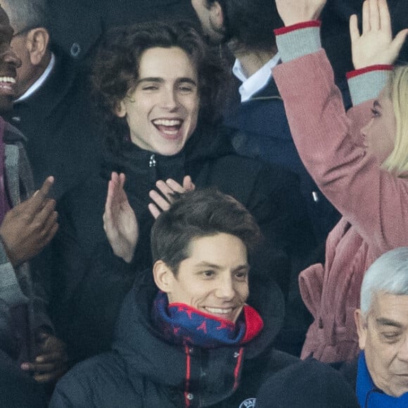 Stéphane Bak, Timothée Chalamet, Florence Pugh dans les tribunes lors du match de Champions League "PSG - Galatasaray (5-0)" au Parc des Princes à Paris, le 11 décembre 2019. © Cyril Moreau/Bestimage