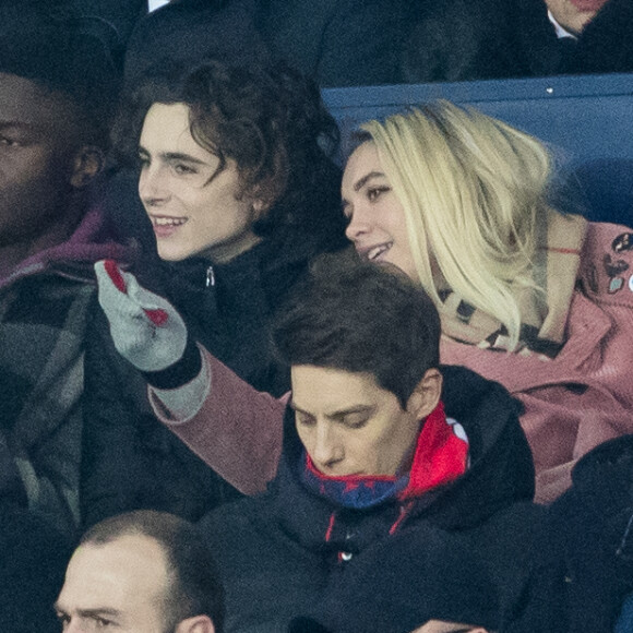 Stéphane Bak, Timothée Chalamet, Florence Pugh dans les tribunes lors du match de Champions League "PSG - Galatasaray (5-0)" au Parc des Princes à Paris, le 11 décembre 2019. © Cyril Moreau/Bestimage