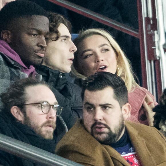 Stéphane Bak, Timothée Chalamet, Florence Pugh, Artus dans les tribunes lors du match de Champions League "PSG - Galatasaray (5-0)" au Parc des Princes à Paris, le 11 décembre 2019. © Cyril Moreau/Bestimage