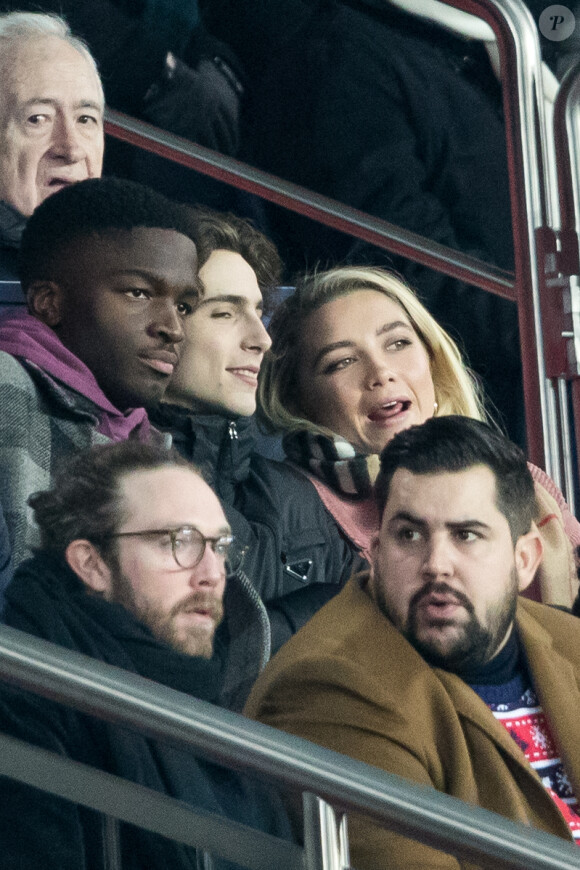 Stéphane Bak, Timothée Chalamet, Florence Pugh, Artus dans les tribunes lors du match de Champions League "PSG - Galatasaray (5-0)" au Parc des Princes à Paris, le 11 décembre 2019. © Cyril Moreau/Bestimage