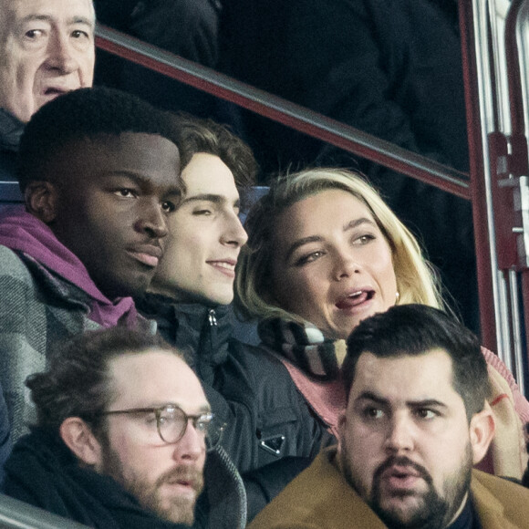 Stéphane Bak, Timothée Chalamet, Florence Pugh, Artus dans les tribunes lors du match de Champions League "PSG - Galatasaray (5-0)" au Parc des Princes à Paris, le 11 décembre 2019. © Cyril Moreau/Bestimage