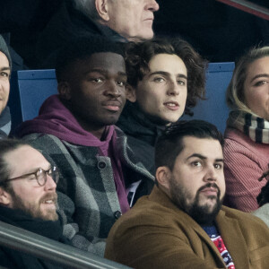 Benjamin Morgaine, Stéphane Bak, Timothée Chalamet, Florence Pugh, Artus, Fary, dans les tribunes lors du match de Champions League "PSG - Galatasaray (5-0)" au Parc des Princes à Paris, le 11 décembre 2019. © Cyril Moreau/Bestimage