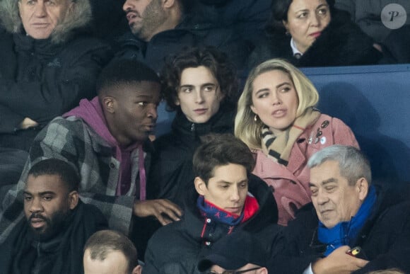 Stéphane Bak, Timothée Chalamet, Florence Pugh dans les tribunes lors du match de Champions League "PSG - Galatasaray (5-0)" au Parc des Princes à Paris, le 11 décembre 2019. © Cyril Moreau/Bestimage