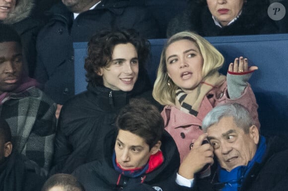 Stéphane Bak, Timothée Chalamet, Florence Pugh dans les tribunes lors du match de Champions League "PSG - Galatasaray (5-0)" au Parc des Princes à Paris, le 11 décembre 2019. © Cyril Moreau/Bestimage