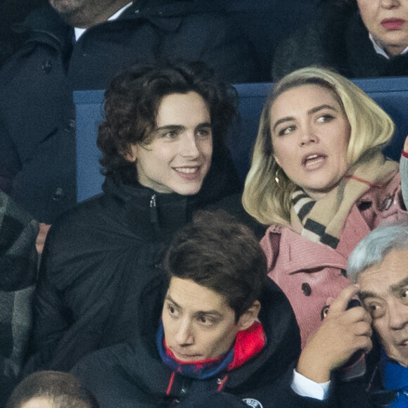 Stéphane Bak, Timothée Chalamet, Florence Pugh dans les tribunes lors du match de Champions League "PSG - Galatasaray (5-0)" au Parc des Princes à Paris, le 11 décembre 2019. © Cyril Moreau/Bestimage