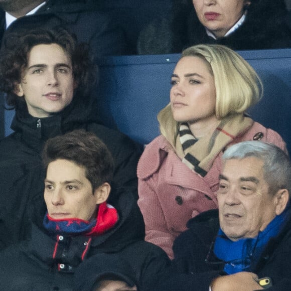 Stéphane Bak, Timothée Chalamet, Florence Pugh dans les tribunes lors du match de Champions League "PSG - Galatasaray (5-0)" au Parc des Princes à Paris, le 11 décembre 2019. © Cyril Moreau/Bestimage