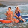 Bella Hadid, Laeticia Hallyday - Laeticia Hallyday rejoint Bella Hadid et son équipe de shooting sur un paddle géant et se baigne sur une plage de Saint-Barthélemy le 7 décembre 2019.