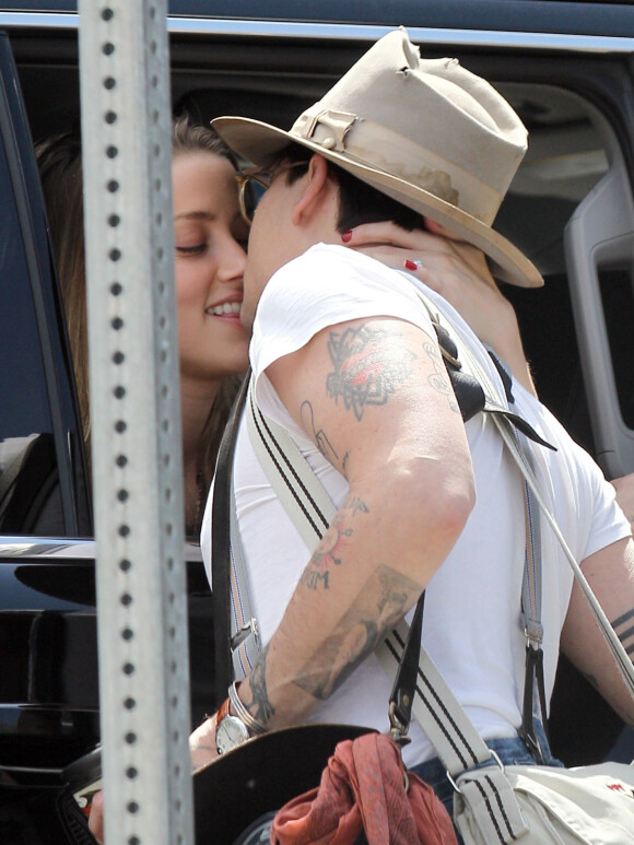 Exclusif - Prix Spécial - Johnny Depp embrasse sa fiancée Amber Heard avant de partir sur un vol à New York le 12 mai 2014.