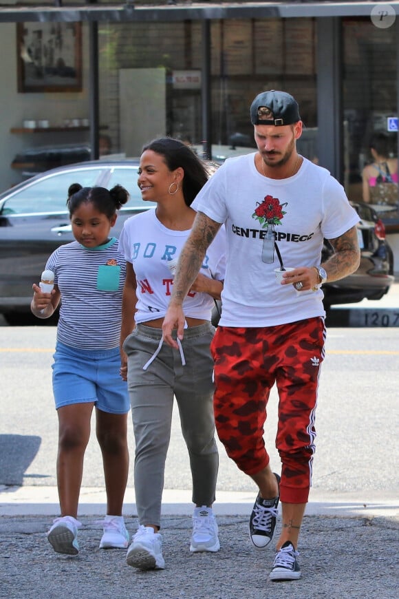 Matt Pokora, sa compagne Christina Milian enceinte et sa fille Violet Nash - Enceinte et radieuse, C.Milian se rend au glacier McConnell avec compagnon M.Pokora et sa fille V.Nash pour le goûter après avoir acheté des vêtements pour bébés. La chanteuse 'Dip it Low' et son compagnon ont annoncé sa grossesse la semaine dernière via Instagram. C'est le premier enfant du couple et le premier enfant de M.Pokora. Los Angeles, le 3 août 2019.