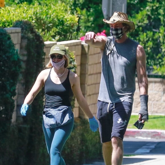 Exclusif - Dax Shepard et sa femme Kristen Bell avec masques et gants de protection se promènent amoureusement dans leur quartier de Los Angeles en pleine épidémie de Coronavirus Covid-19 le 21 avril 2020.