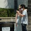 Exclusif - Elle Fanning et son compagnon Max Minghella font des selfies avec leurs masques lors d'une balade à Los Angeles, le 12 mai 2020.