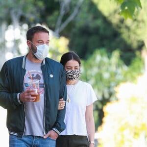 Exclusif - Ben Affleck et Ana de Armas, équipés de masques, se promènent avec le chien de l'actrice tandis que Ben Affleck se désaltère avec une boisson fraîche à Los Angeles, le 14 mai 2020.