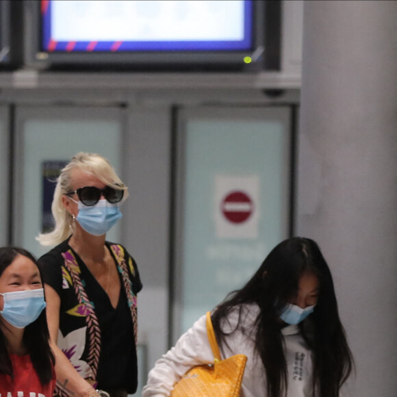 Semi-exclusif - Laeticia Hallyday et ses filles Jade et Joy arrivent, avec des masques de protection contre l'épidémie de coronavirus (Covid-19), à l'aéroport de Paris-Charles-de-Gaulle à Roissy-en-France, France, le 18 juin 2020.