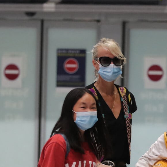 Semi-exclusif - Laeticia Hallyday et ses filles Jade et Joy arrivent, avec des masques de protection contre l'épidémie de coronavirus (Covid-19), à l'aéroport de Paris-Charles-de-Gaulle à Roissy-en-France, France, le 18 juin 2020.