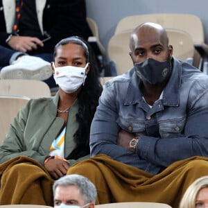 Teddy Riner et sa compagne Luthna Plocus en tribune lors de la finale homme des internationaux de tennis de Roland Garros à Paris remportée par Rafael Nadal en trois set le 11 octobre 2020. © Dominique Jacovides / Bestimage