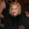 Madonna porte un manteau Versace et marche à l'aide d'une canne à la sortie du London Palladium à Londres.