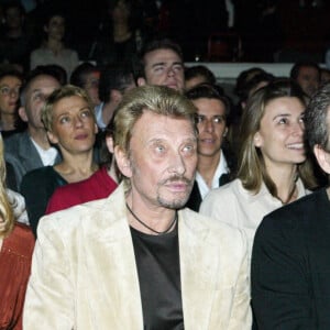 Johnny Hallyday, Laeticia et son père André Boudou au club l'Amnesia en 2004. 