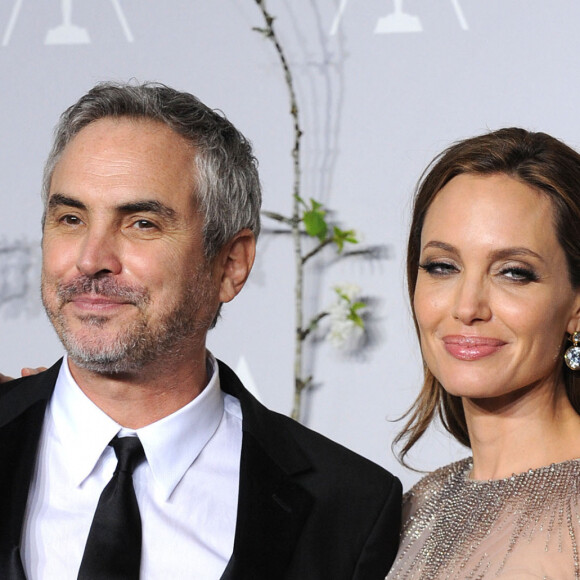 Alfonso Cuaron, Angelina Jolie - Pressroom - 86ème cérémonie des Oscars à Hollywood, le 2 mars 2014. 