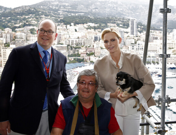 Le prince Albert II et la princesse Charlène de Monaco, avec son chien Monté, ont rendu visite aux spectateurs de la tribune de l'association monégasque des handicapés moteur, lors des essais du Grand Prix de Monaco. Le 23 mai 2015.