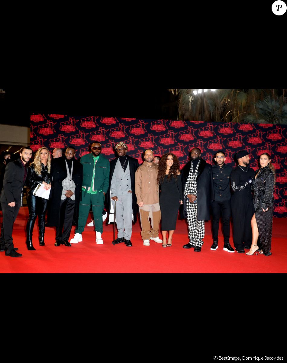 Tom Bosc (Indifférence Prod), Coralie Baud (attachée de presse d'Indifférence Prod), Abou Debeing, Gims, Dadju, Saïd Boussif (PDG d'Indifference Prod), Amel Bent (enceinte), Slimane et Vitaa lors de la 23ème édition des NRJ Music Awards 2021 au Palais des Festivals de Cannes, le 20 novembre 2021. © Dominique Jacovides/Bestimage