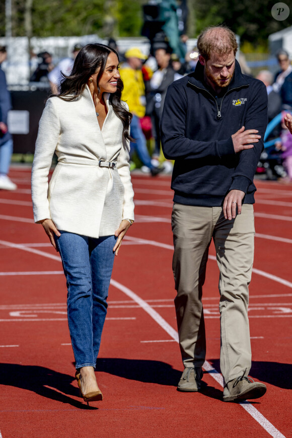 Le prince Harry et Meghan Markle assistent à la finale d'athlétisme, au deuxième jour des Invictus Games 2020 à La Haye, le 17 avril 2022. 