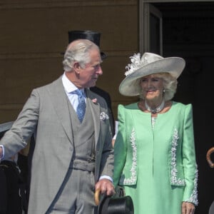 Camilla Parker Bowles, duchesse de Cornouailles, le prince Harry, duc de Sussex, et Meghan Markle, duchesse de Sussex, lors de la garden party pour les 70 ans du prince Charles au palais de Buckingham à Londres. Le 22 mai 2018 
