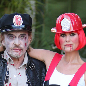 Exclusif - Laeticia Hallyday et Johnny Hallyday et leurs filles Jade et Joy se rendent a une soiree d'Halloween a Los Angeles le 31 octobre 2013. Johnny etait habille en flic zombie et laeticia en pompier zombie. Elyette, la grand mere de Leaticia faisait egalement partie de la fete. 