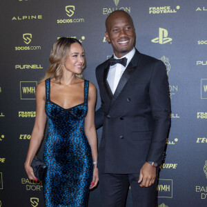 Sur son compte Instagram, Gabrielle Lemaire s'affiche en bikini et en robe moulante. L'occasion de voir qu'elle est déjà à un stade avancé de sa grossesse
 
Didier Drogba et et sa compagne Gabrielle Lemaire - Photocall de la cérémonie du Ballon d'Or 2021 au Théâtre du Châtelet le 29 novembre 2021. © Cyril Moreau/Bestimage