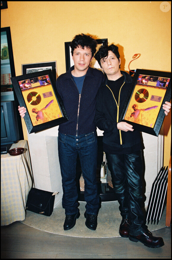 Nicola et Stéphane Sirkis d'Indochine avec leur disque d'or en 1998