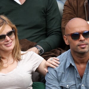 Eric Judor et sa nouvelle compagne enceinte aux Internationaux de France de tennis de Roland Garros à Paris, le 29 mai 2014.