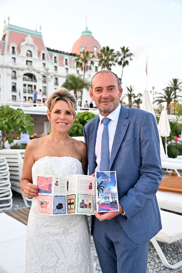 Exclusif - Laura Tenoudji Estrosi et Lionel Servant, le directeur général de l'hôtel Negresco, durant la présentation du 5eme guide des adresses incontournables by Laura Tenoudji Estrosi à la plage de l'hôtel Negresco à Nice, le 23 juin 2023. On connaissait "Laura du Web", dorénavant il faut aussi compter avec "Laura de Nice". Laura et ses bons tuyaux, va permettre aux futurs vacanciers descendus dans le mythique Palace niçois, le Negresco, de découvrir un petit guide avec des adresses niçoises et azuréennes incontournables, comme les restaurants : La Petite Maison, Nespo ou encore La Javanaise, la nouvelle plage de Hugo Lloris à Beaulieu, la nouvelle patisserie de Juliien Dugourd, les parfums Molinards ou le quartier des Antiquaires au port... Dans cette édition quelques nouveautés comme une interview de Richard Orlinski, qui a dessiné la couverture et les illusttration du guide et qui nous dévoile ses coups de coeur niçois, ou 3 conseils de Sarah Lavoine pour se sentir mieux dans son intérieur... Avec Longchamp, Mercedes by My Car Côte d'Azur, Eric Bompard, les bijouteries Auberi, les bijoux APM Monaco, les Galeries Lafayette, la Maison Sarah Lavoine comme partenaire et le Negresco, Laura va sortir son guide tous les semestres. D'un 4 pages pour sa première édition, les nouvelles éditions ont grandi avec beaucoup plus d'adresses et donc beaucoup plus de feuillets qui se présentent en forme d'accordéon, facile à ranger et surtout pratique pour les touristes. Ce guide est aussi en vente dans la boutique de l'hôtel, pour la somme de 5 euros qui seront reversés au profit de l'hôpital Lenval pour enfant. © Bruno Bebert/Bestimage