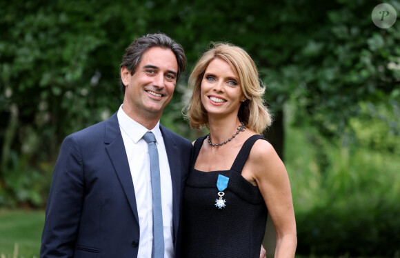 Exclusif - Sylvie Tellier et son mari Laurent Schenten - La présidente de l'association "Les Bonnes Fées", l'ancienne directrice générale d'un concours national de beauté et Miss France 2022, Sylvie Tellier décorée des l'insignes de chevalier de l'ordre national du Mérite par la secrétaire d'Etat, chargée de l'Économie sociale et solidaire et de la Vie associative dans les jardins de l'hôtel Matignon à Paris, France, le 26 juin 2023. C'est son investissement dans le milieu associatif qui vaut à l'ancienne directrice de miss France, cette distinction. Sylvie Tellier est co-fondatrice, avec plusieurs anciennes miss France, de l'association Les Bonnes fées, qui a pour objectif d'améliorer les conditions de vie des femmes à travers le financement de projets comme la création d'un lieu de détente dans les centres de cancérologie des hôpitaux ou des ateliers socio-esthétiques pour des femmes atteintes d'un cancer. © Dominique Jacovides/Bestimage