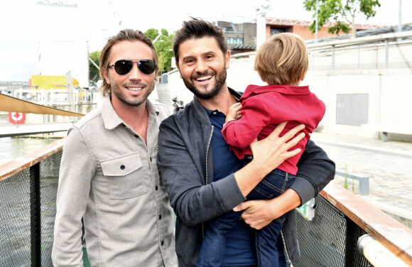 Christophe Beaugrand, son mari Ghislain Gerin et leur fils Valentin - Soirée d'anniversaire des 5 ans de la marque Joone, sur la péniche La Barge à Issy-les-Moulineaux. Paris, le 30 juin 2022 © Veeren / Bestimage