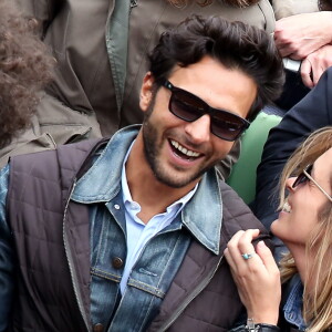 Maxim Nucci (Yodelice) et sa compagne Isabelle Ithurburu dans les tribunes des Internationaux de France de tennis de Roland Garros à Paris. Le 24 mai 2016 © Dominique Jacovides / Bestimage