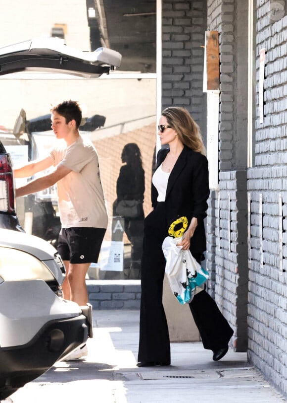 L'adolescent dépasse maintenant sa mère, pourtant chaussée de chaussures à talons. 
Angelina Jolie et son fils Knox à la sortie d'une animalerie de Los Angeles, le 7 juillet 2024