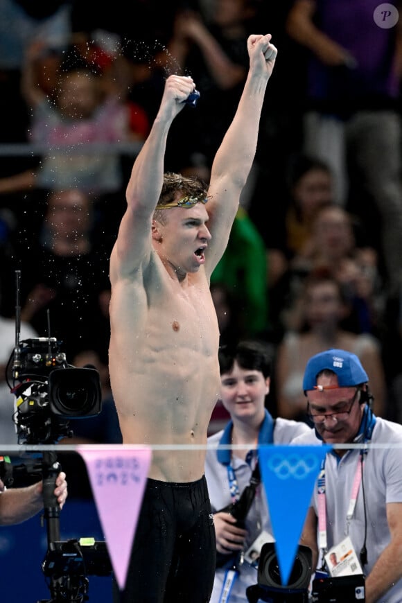 Leon Marchand of France celebrates after winning the gold medal in the swimming 200m Individual Medley Final, the 4th gold medal in individual events, during the Paris 2024 Olympic