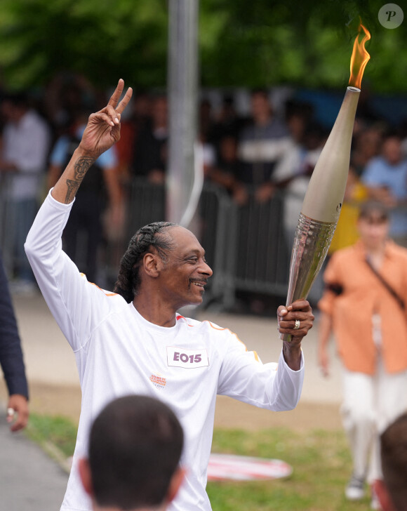 Avant les Jeux olympiques d'été, les Jeux olympiques de Paris 2024, le relais de la flamme. Le rappeur américain Snoop Dogg porte la torche lors du relais de la flamme. Paris, France, 26 juillet 2024. Photo par Marcus Brandt/DPA/ABACAPRESS.COM