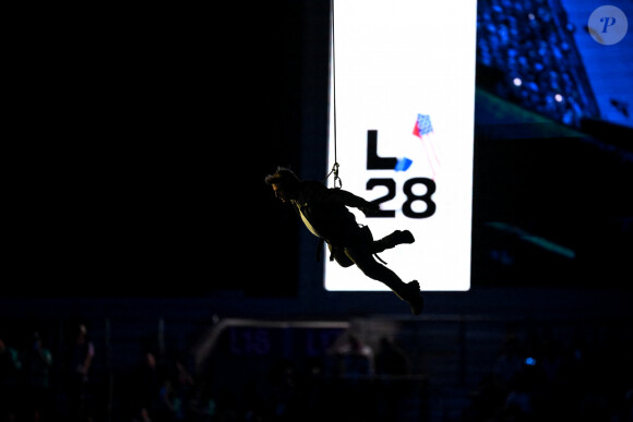 Tom Cruise, accroché à un fil, descend du toit du stade de France pour prendre le drapeau olympique des mains de l'athlète américaine, S.Biles, sous le regard de K.Bass, maire de Los Angeles, où se dérouleront les prochains jeux olympiques d'été en 2028 - Cérémonie de clôture des Jeux Olympiques de Paris 2024 au stade de France à Saint-Denis, le 11 août 2024. 270 artistes, 8200 athlètes et accompagnants issus de 205 délégations se succèdent dans le stade, devant 72.0000 spectateurs, avec la cycliste française P.Ferrand-Prévot et le joueur de rugby français, A.Dupont comme porte-drapeau pour la France. Comme pour la cérémonie d'ouverture, la direction artistique de cet événement est signée, T.Jolly. Au programme de cette soirée, cérémonie des médailles, discours et extinction de la flamme olympique, le show artistique baptisé " Records ", les groupes Air et Phoenix pour la partie musicale tandis que l'acteur américain T.Cruise participe à cet événement. K.Bass, maire de Los Angeles, reçoit le drapeau olympique des mains de la maire de Paris, A.Hidalgo, quatre ans avant les prochains Jeux Olympiques d'été dans la cité des anges. © Jacovides-Perusseau / Bestimage