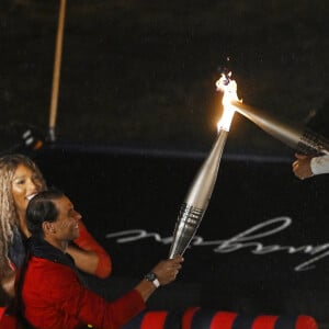 L'ancienne joueuse de tennis Amélie Mauresmo et le joueur de tennis espagnol Rafael Nadal sont vus portant des torches olympiques lors de la cérémonie d'ouverture des Jeux olympiques de Paris 2024 à Paris, le 26 juillet 2024. Photo par Xinhua/Wang Peng/ABACAPRESS.COM