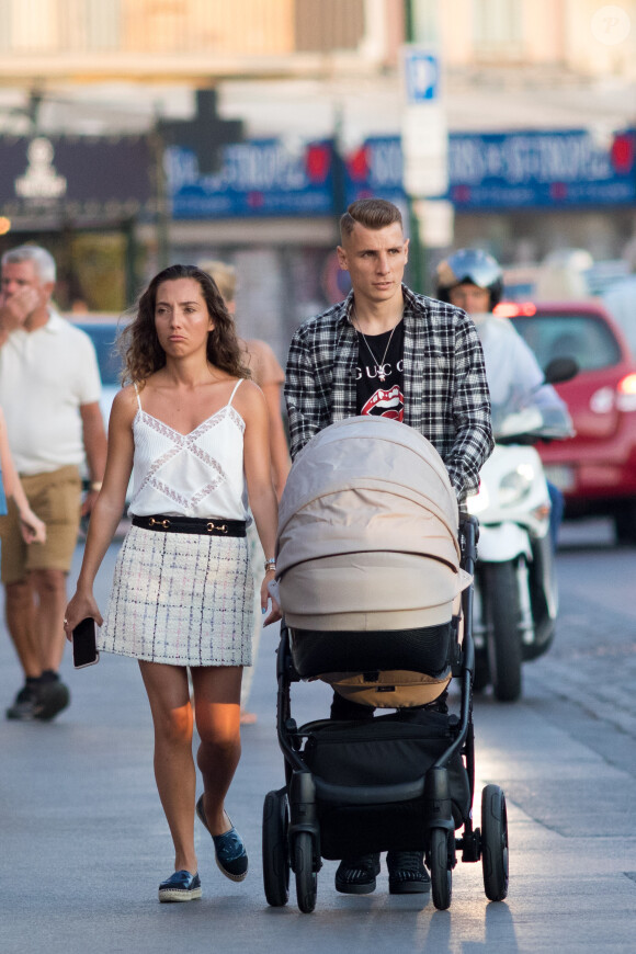 Exclusive - Le joueur de l'équipe de France et d'Everton, Lucas Digne se promène en famille, avec sa femme Tiziri et leur petit garçon sur le port de Saint-Tropez, Côte d'Azur, France, le 28 juin 2019.