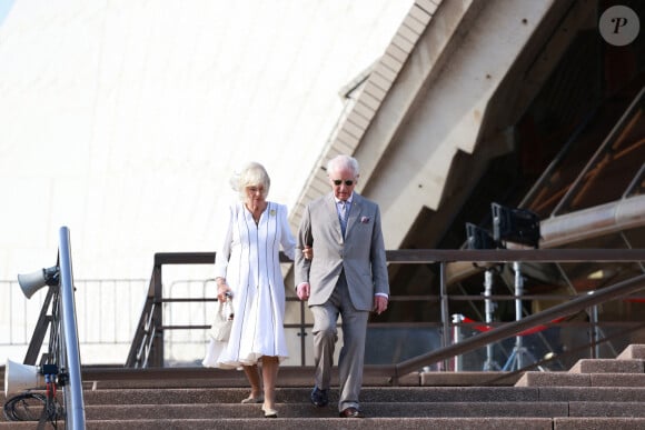 Le roi Charles III d'Angleterre et Camilla Parker Bowles, reine consort d'Angleterre, descendent l'escalier de l'opéra de Sydney lors de leur visite officielle en Australie, le 22 octobre 2024. 